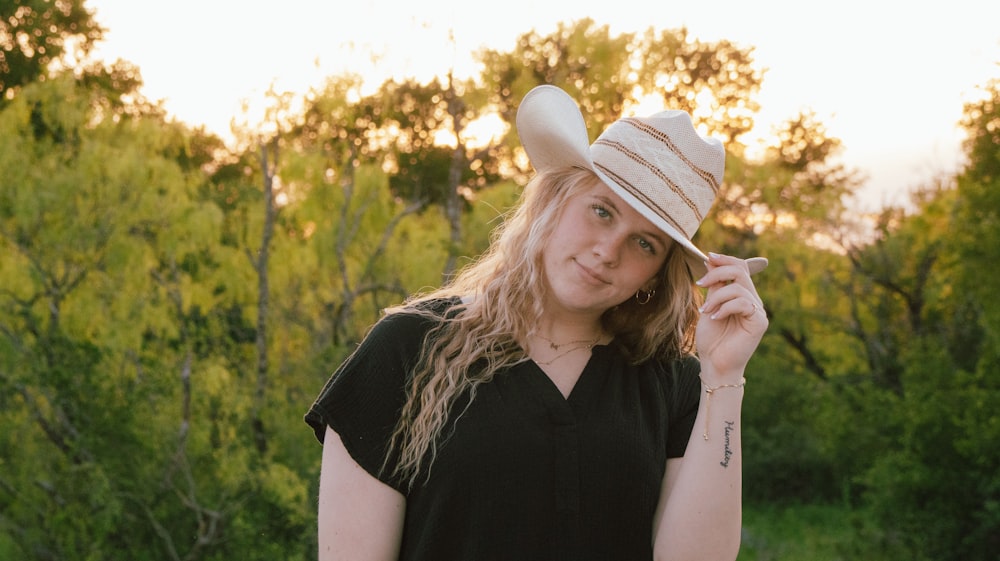 a woman in a black shirt and a white hat