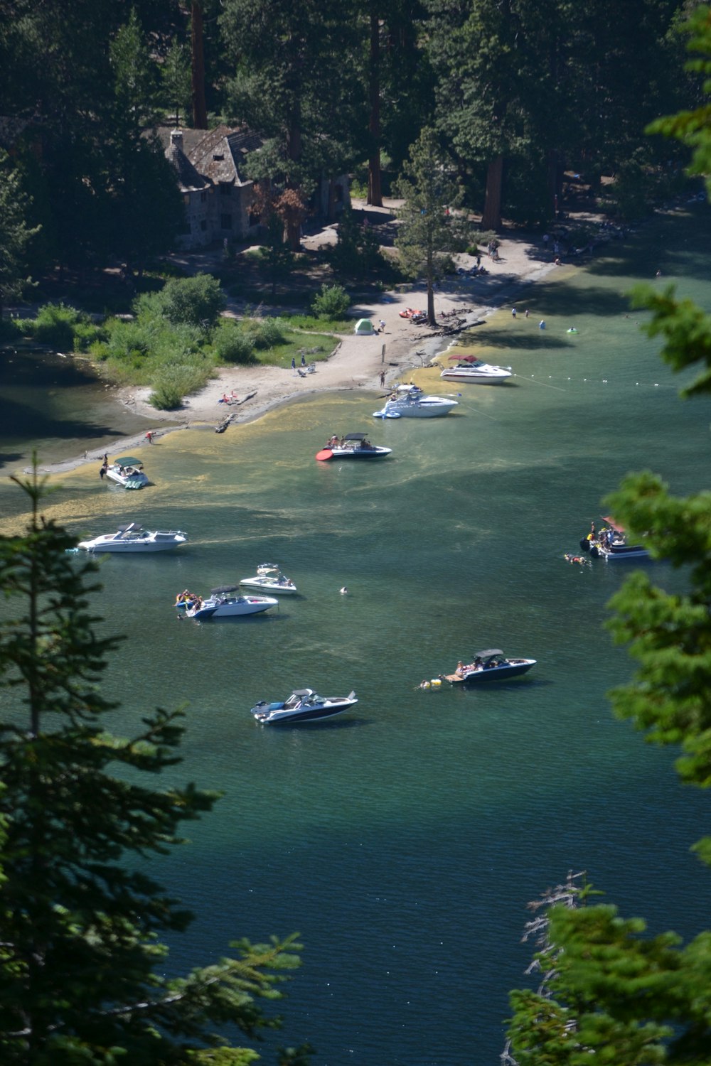 a group of boats floating on top of a lake