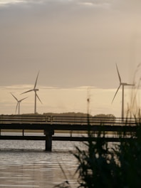 a couple of windmills sitting on top of a bridge