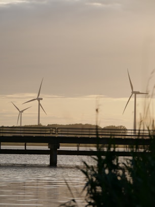 a couple of windmills sitting on top of a bridge
