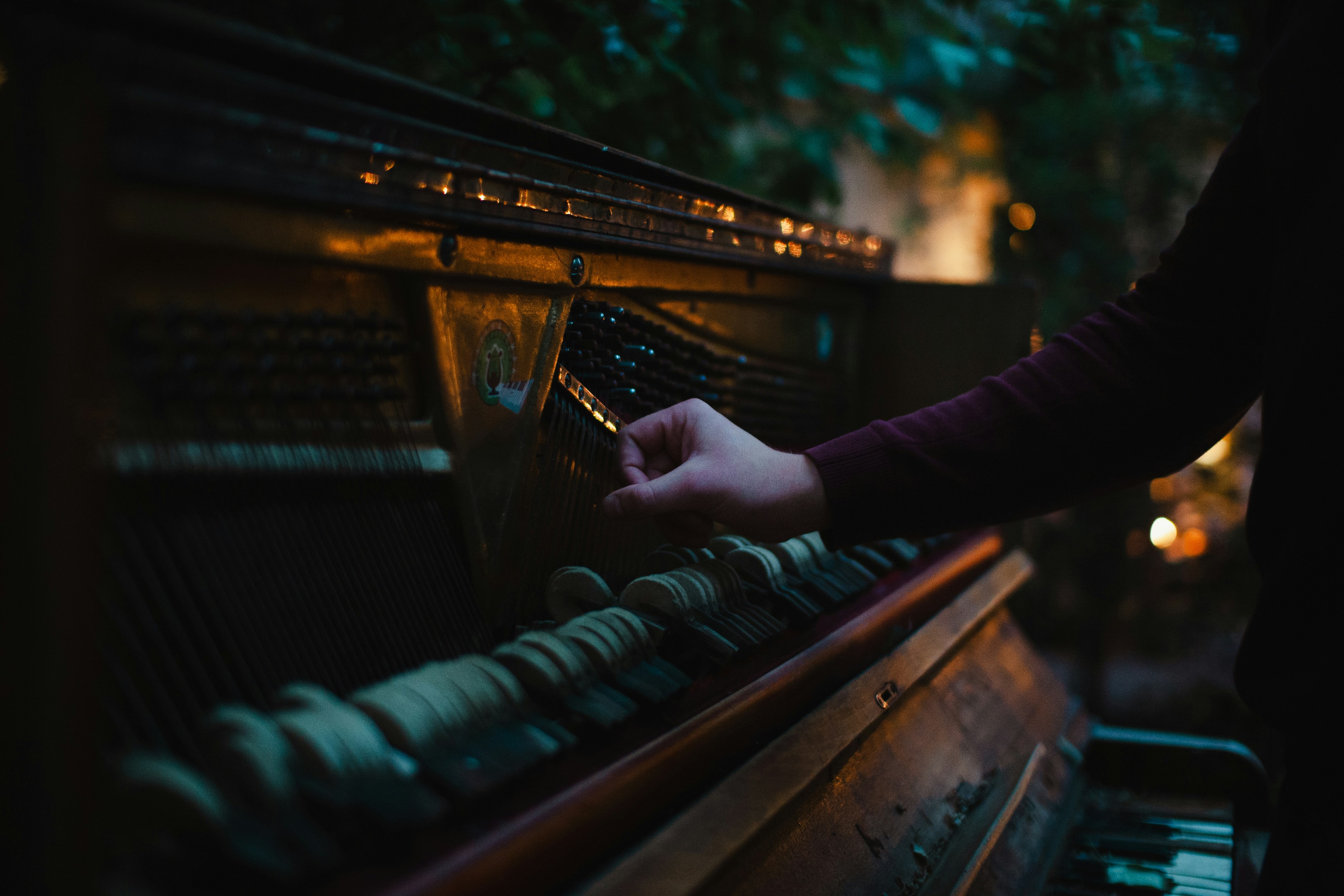 a person is playing a piano outside at night