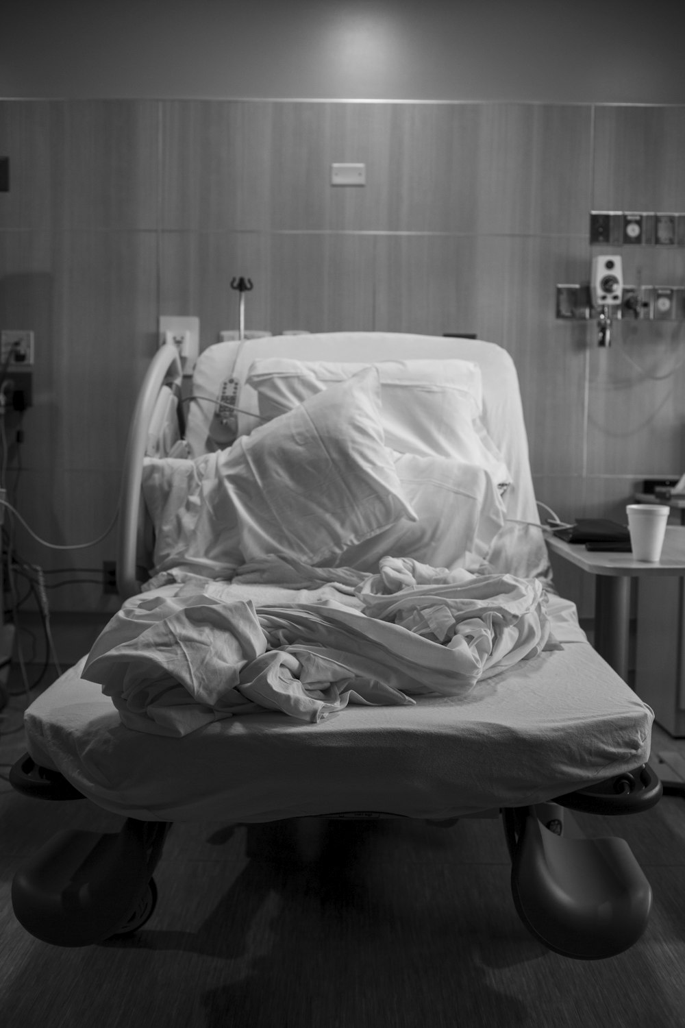 a black and white photo of a hospital bed