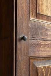 a close up of a door handle on a wooden door