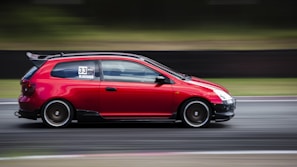 A high-speed racing car on a track during a competition.