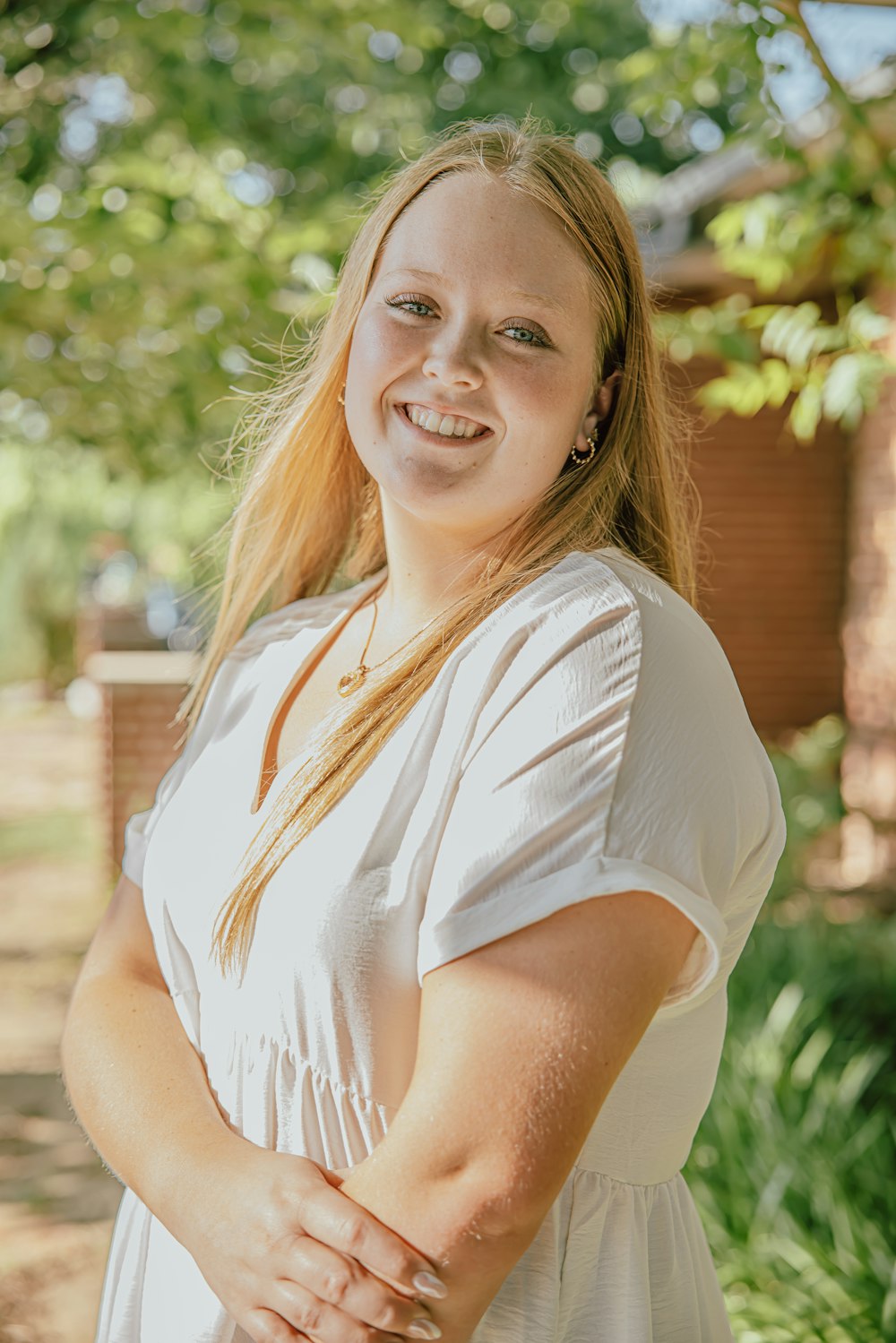 a woman in a white dress posing for a picture