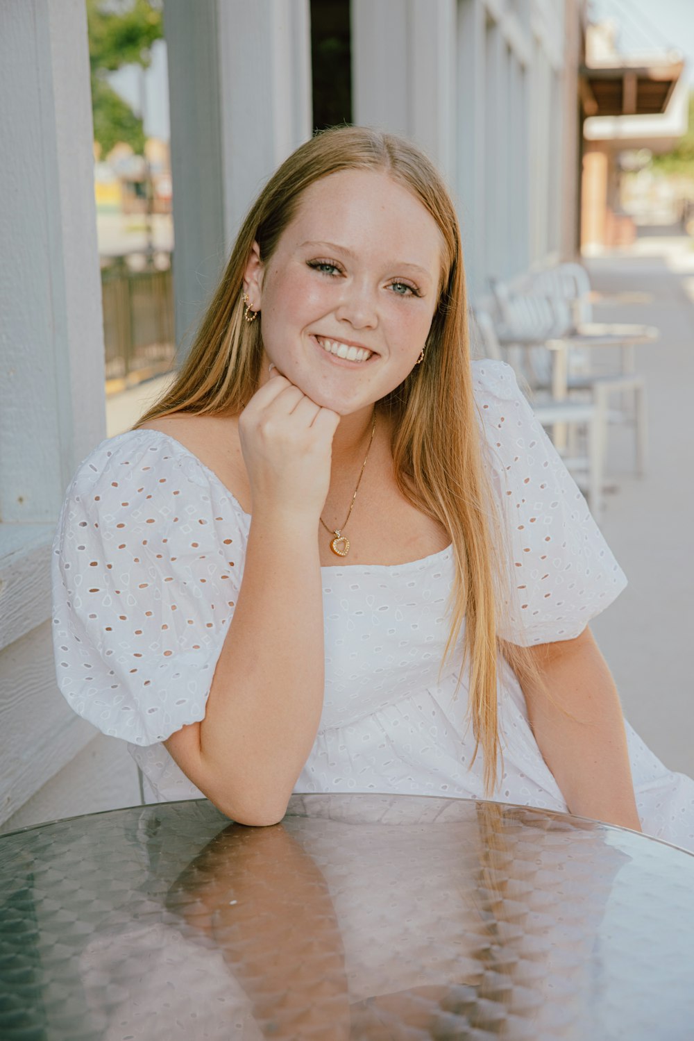 a woman sitting at a table with a smile on her face