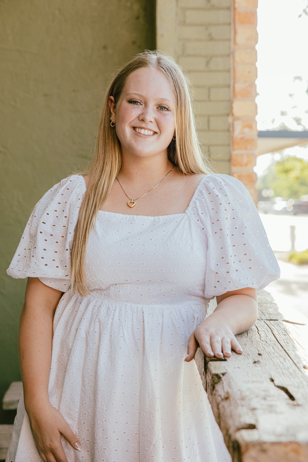 a woman in a white dress posing for a picture