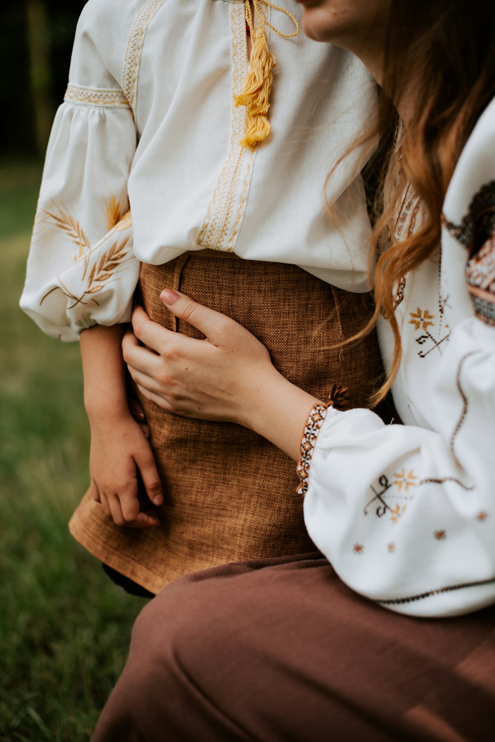 a woman in a white blouse and brown skirt