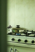 A Safegas branded cylinder connected neatly to a gas stove ready for cooking.