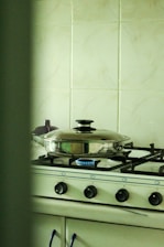 Professional technician examining a gas stove in a modern kitchen setting.