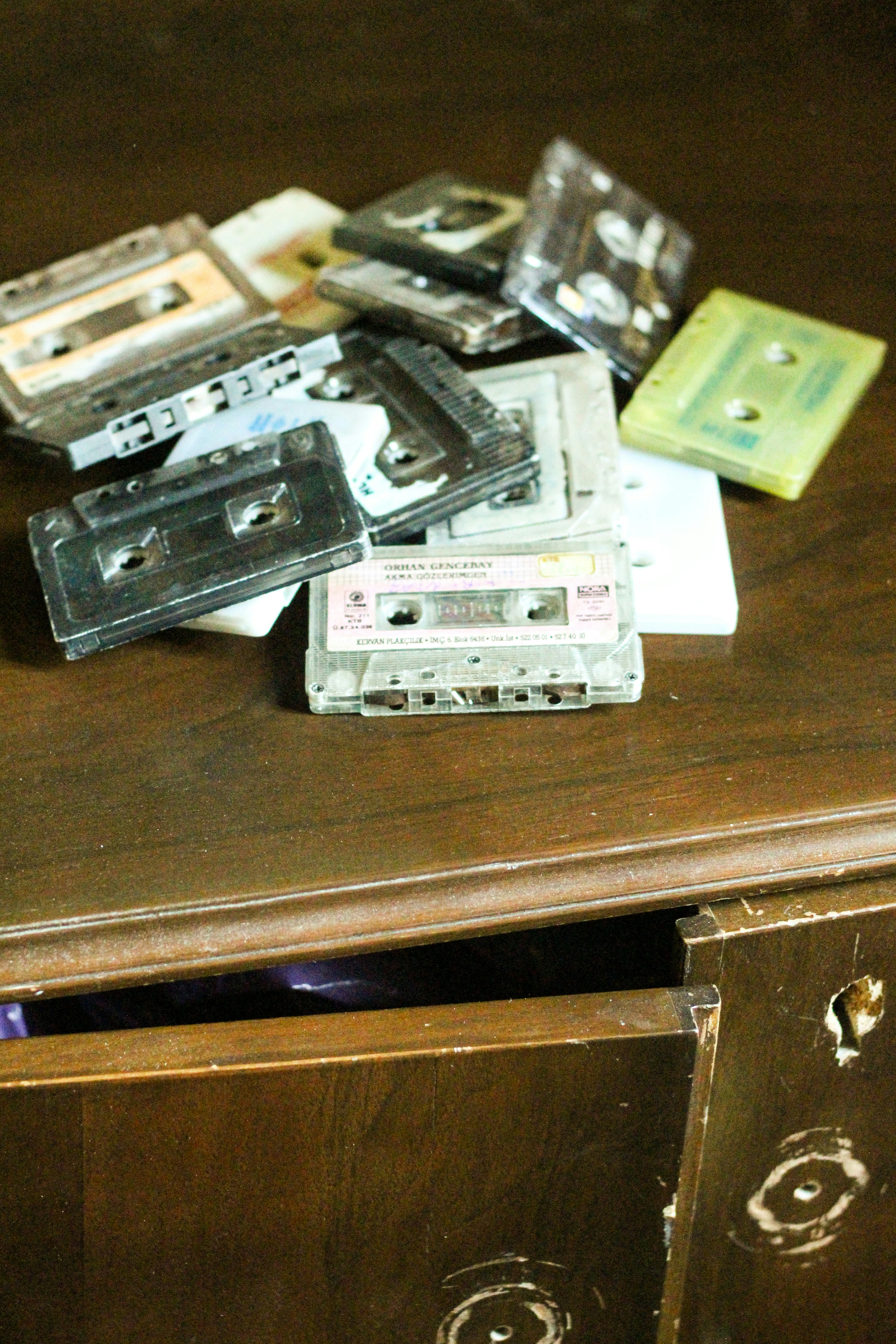 a wooden table topped with lots of cassettes
