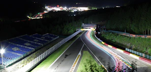 Evening scene of the track illuminated with warm lights, capturing the excitement after races