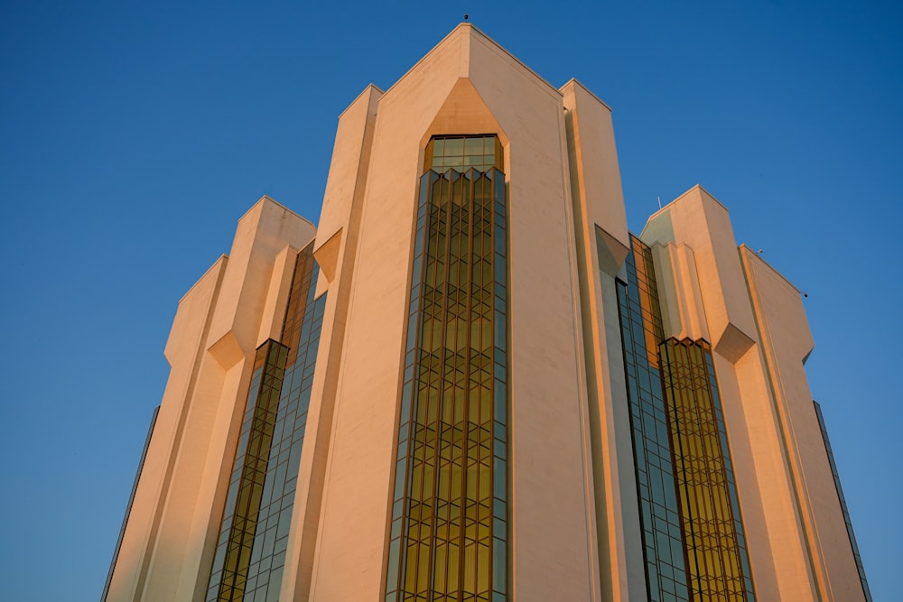 a tall building with stained glass windows against a blue sky