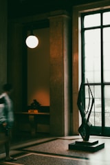 A custom stone sculpture centerpiece gracefully glowing in a beautifully lit foyer.