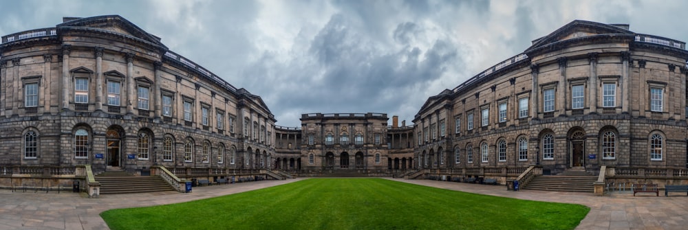 a large building with a green lawn in front of it