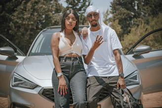 Close-up of a happy couple reviewing financing options with a friendly Fiducia Motors advisor.