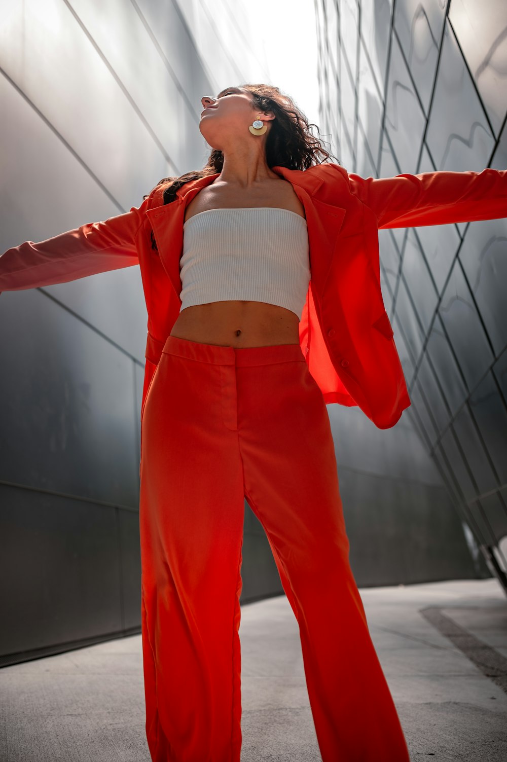 a woman in red pants and a white top