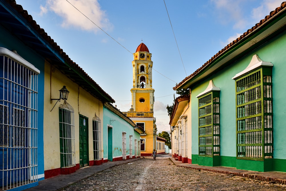 a clock tower towering over a city street