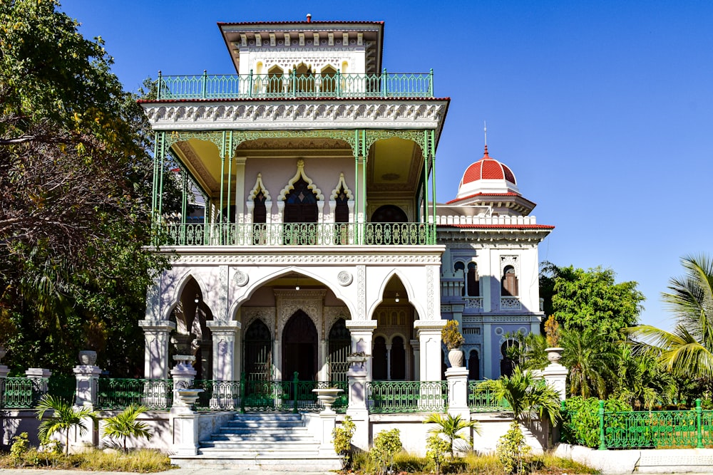 a large white building with a red dome on top of it