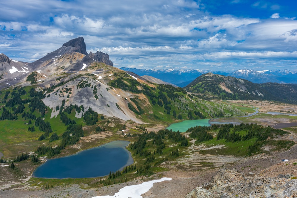 a view of a mountain range with a lake in the foreground