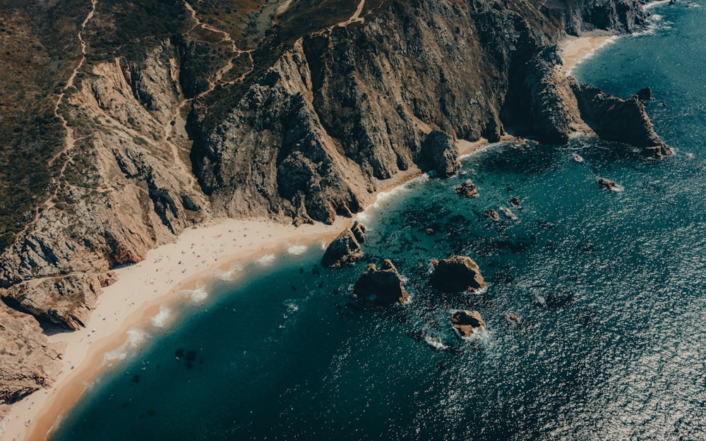 an aerial view of a beach and mountains