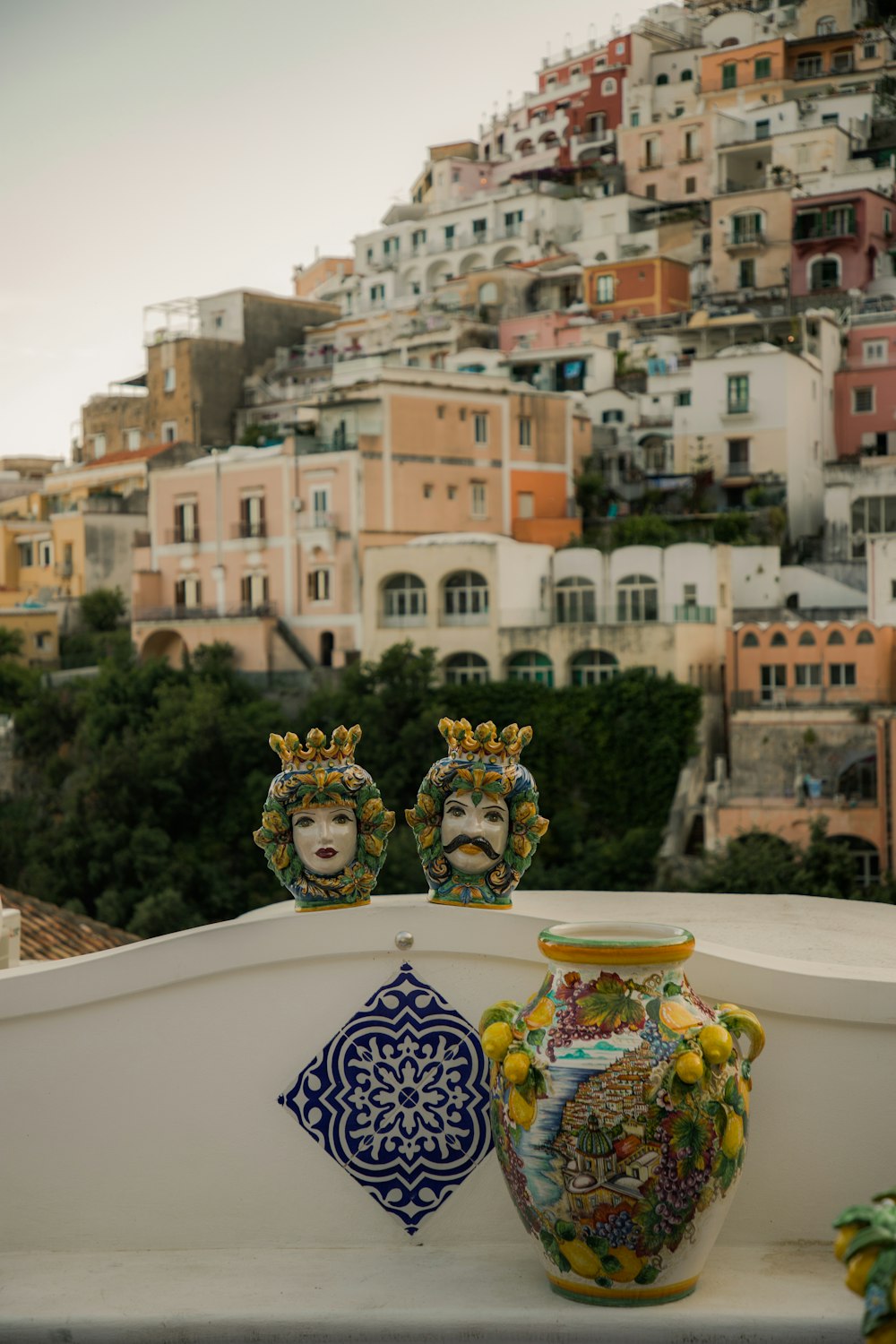 a group of vases sitting on top of a white wall