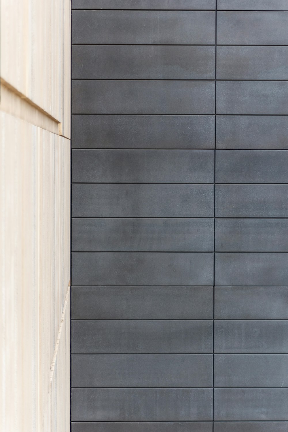 a man walking down a street next to a tall building