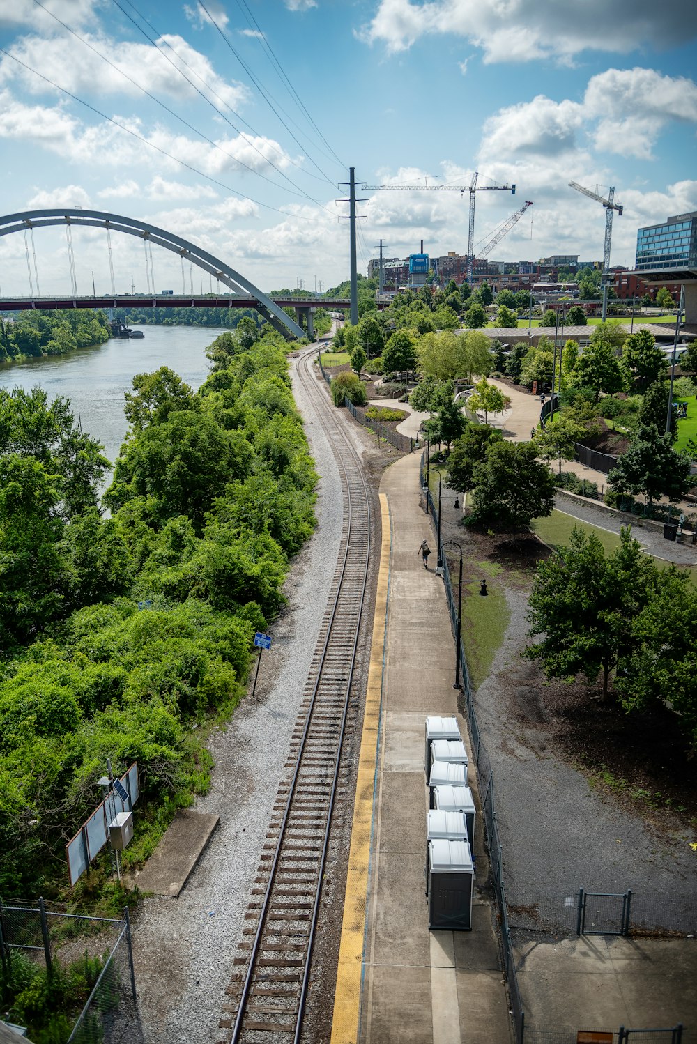 a train traveling down tracks next to a river