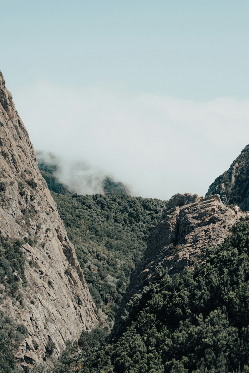 a view of a mountain with a few clouds in the sky