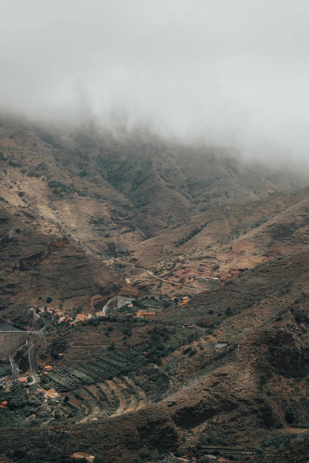 a view of a mountain with a small town in the distance