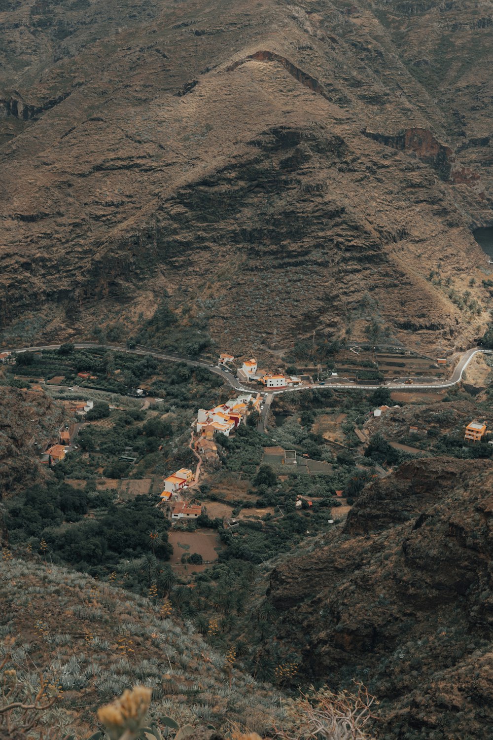 a scenic view of a village in the mountains