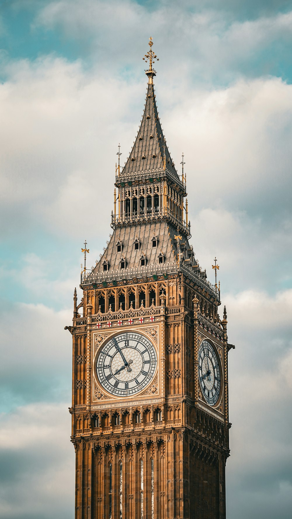 a clock tower with a cloudy sky in the background