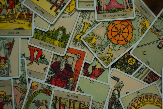 a pile of playing cards sitting on top of a table