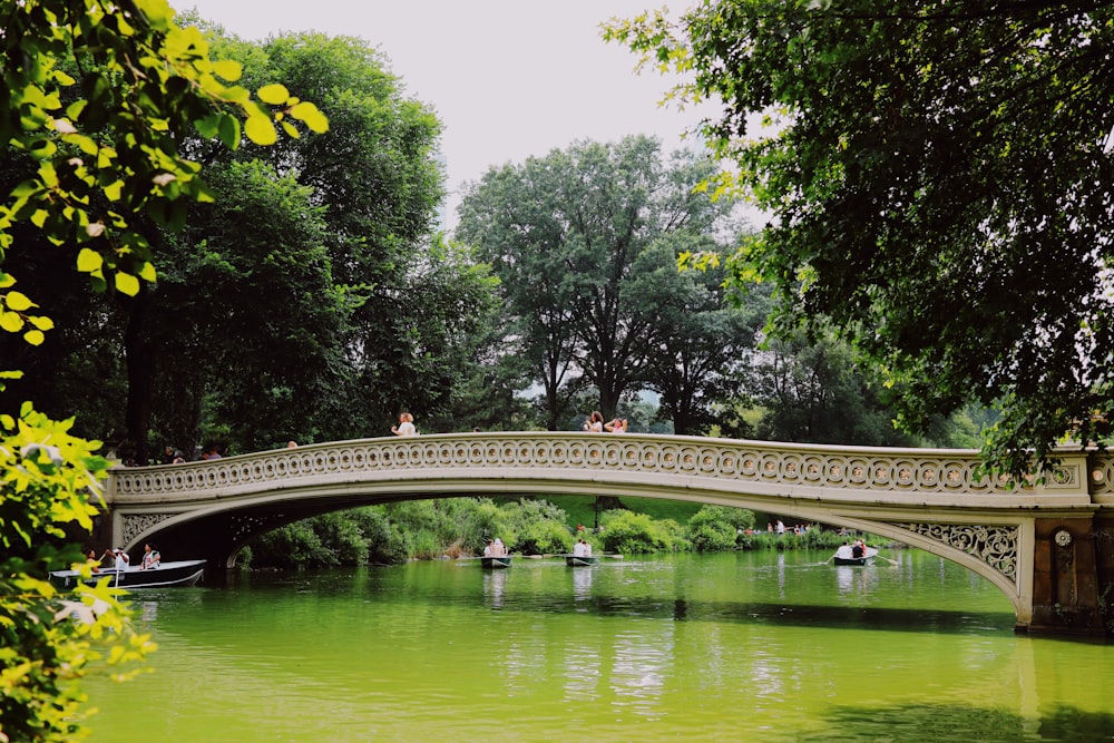 a bridge over a river with boats on it