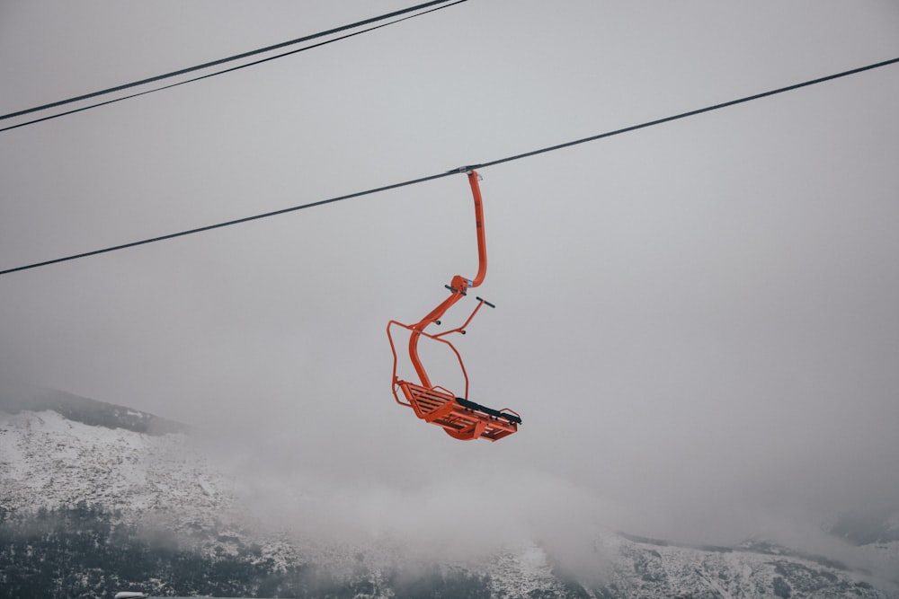 a ski lift going up a snowy mountain