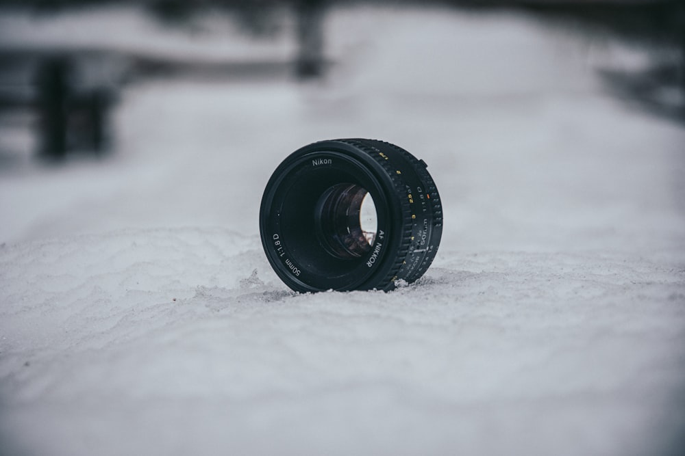 a camera lens laying in the snow