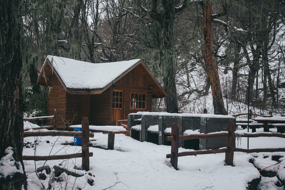 a cabin in the woods covered in snow