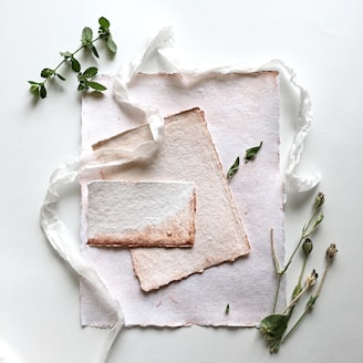 A delicate arrangement of feminine paper goods in soft pink and neutral tones, reflecting an eco-friendly approach.