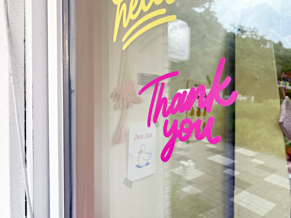 a window with a thank you sign on it