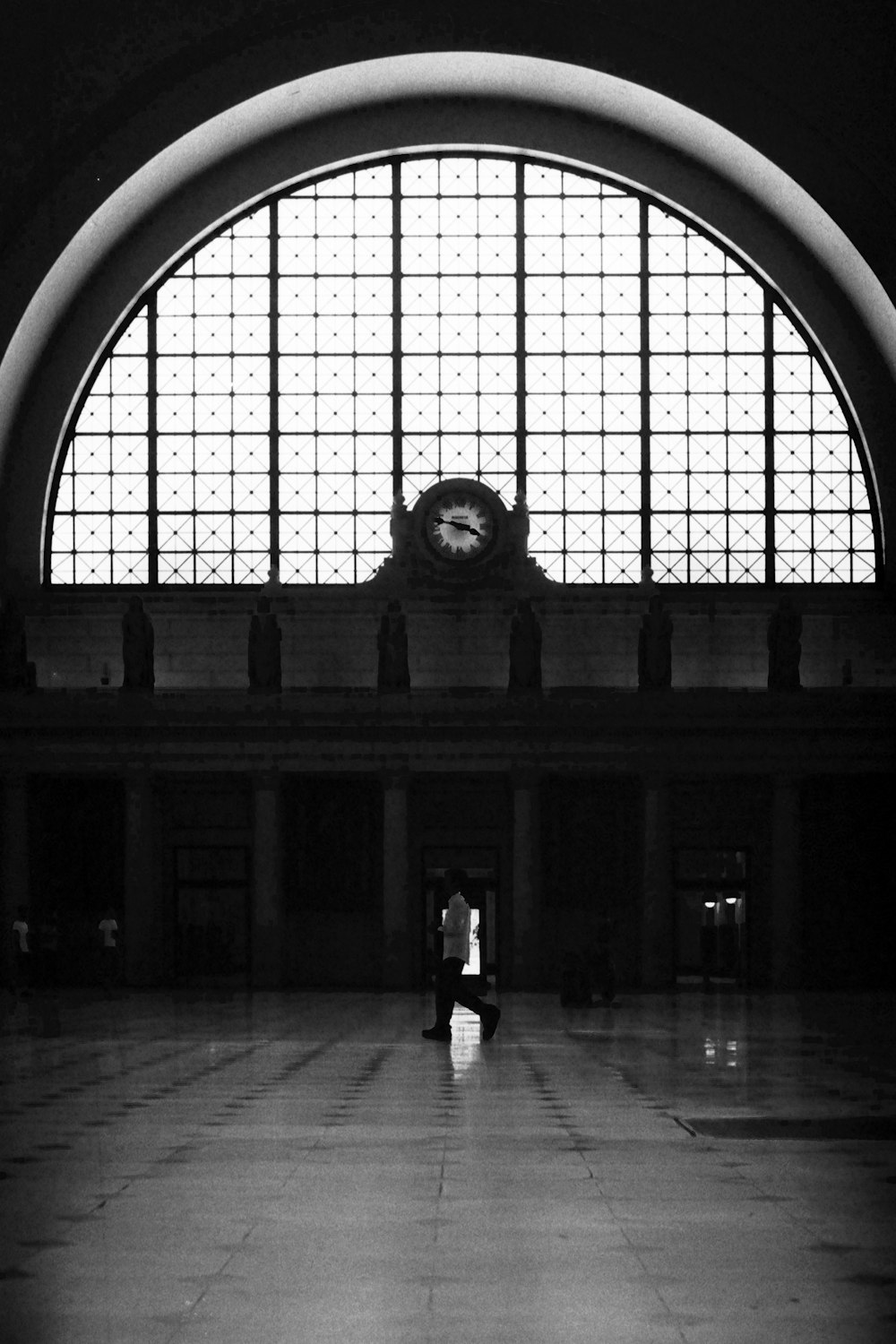 a black and white photo of a large window in a building