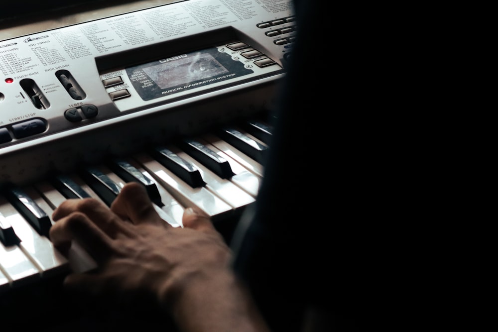a person is playing a musical keyboard in the dark