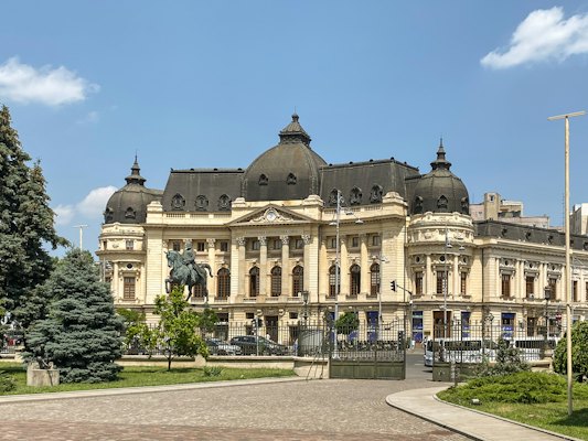 A large building with a clock tower on top of it — Bucharest, Romania