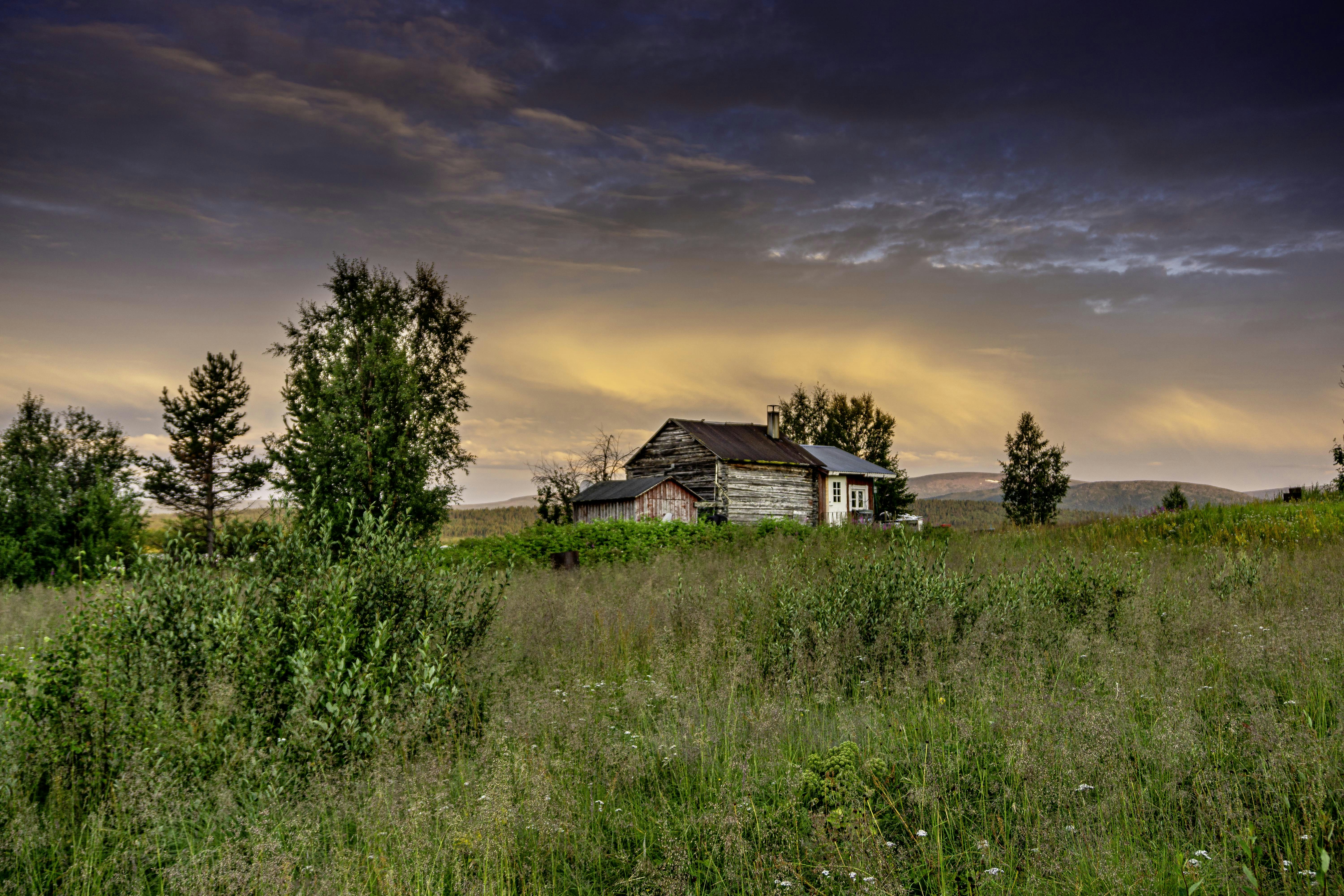 a house in the middle of a grassy field