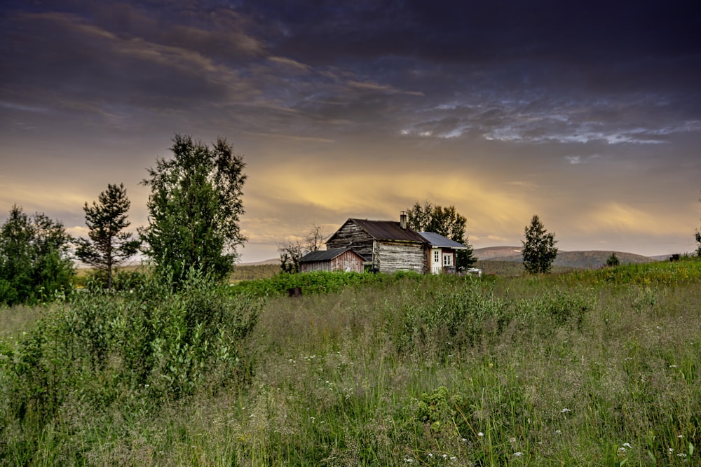 a house in the middle of a grassy field