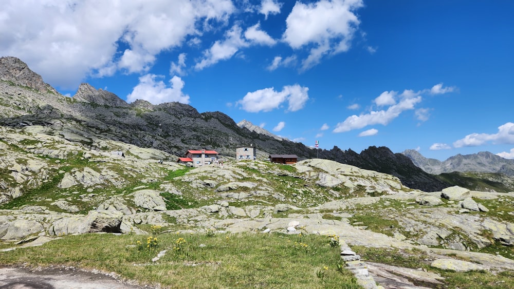 a house on a rocky hill with a blue sky in the background