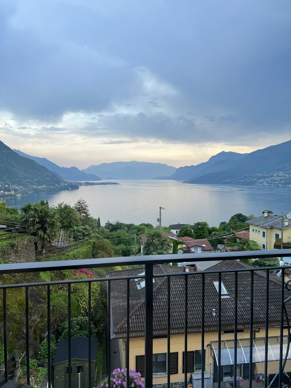 a balcony with a view of a lake and mountains
