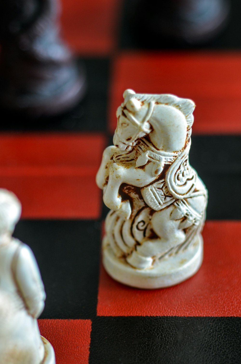 a close up of a chess board with figurines on it