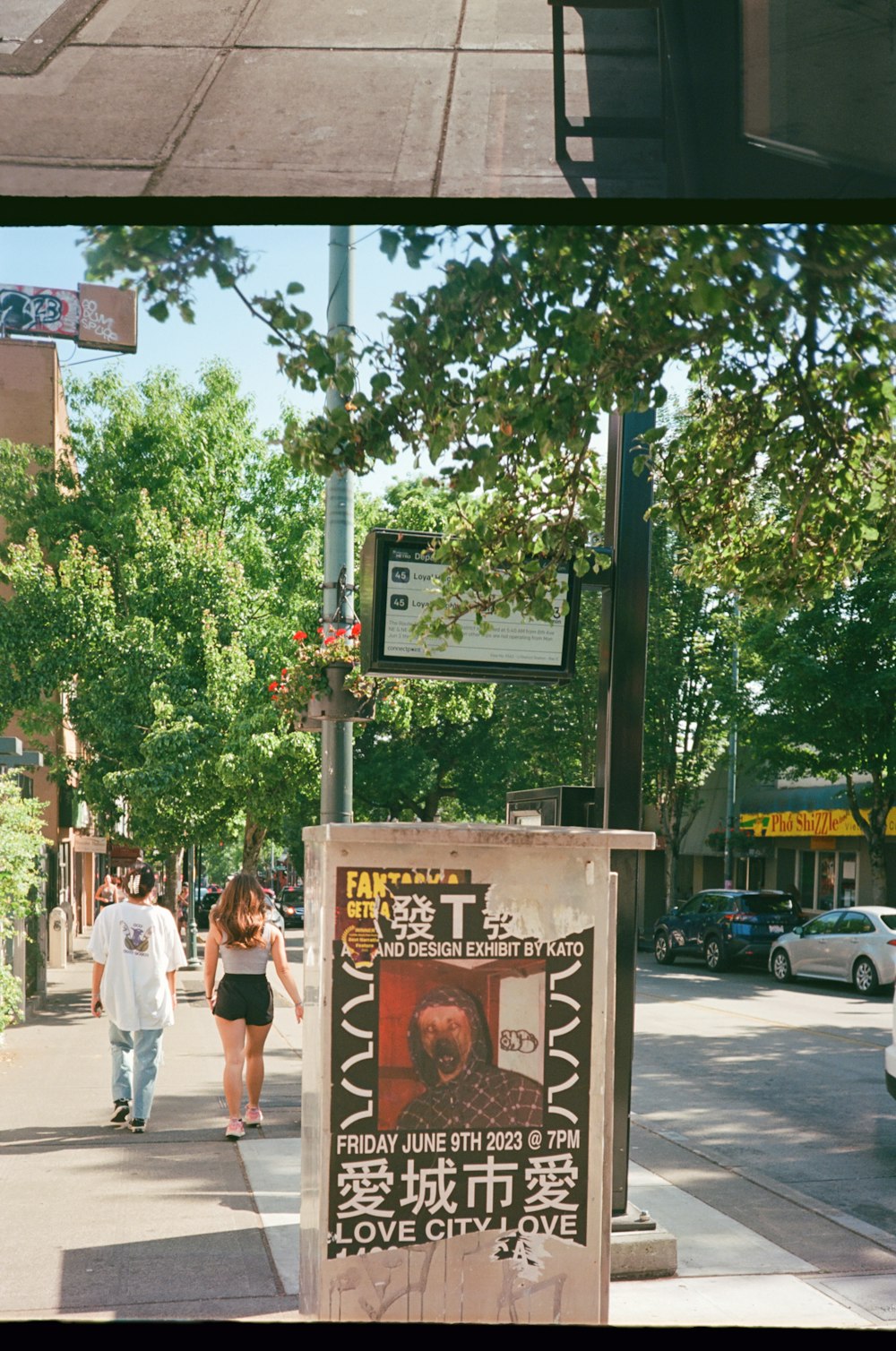 a couple of people walking down a sidewalk