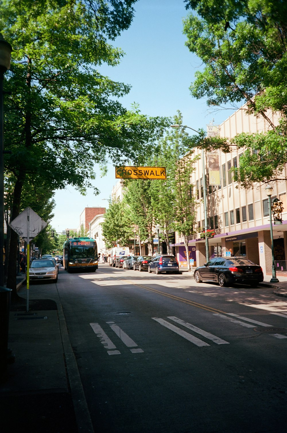 a city street with cars and a street sign