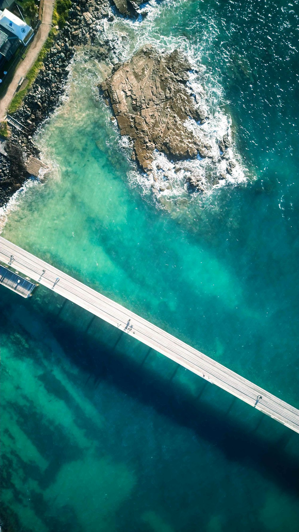 an aerial view of a bridge over a body of water